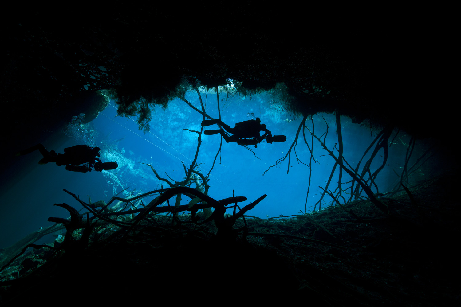 Mexico, Tulum, 2 cave divers at the entrance to cenote car wash