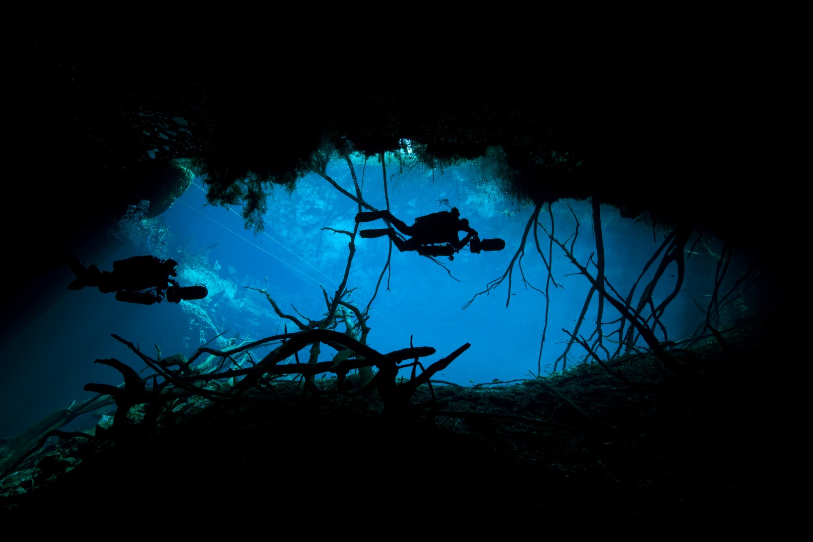 Mexico, Tulum, 2 cave divers at the entrance to cenote car wash